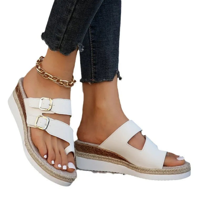 White patent leather women's wedge sandals with finger fit straps and woven detail, peep toe.