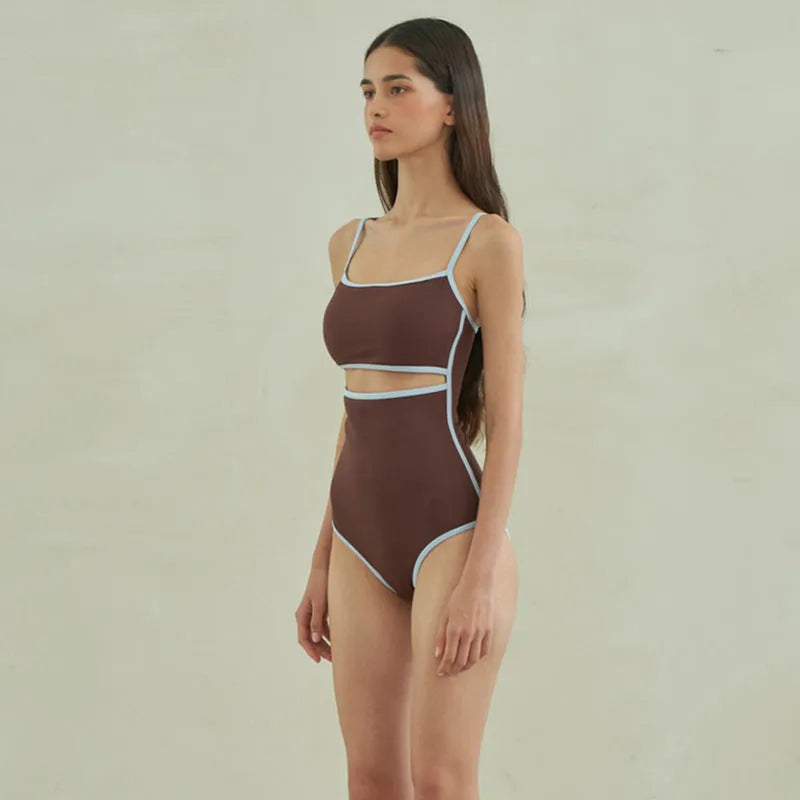Brown one-piece swimsuit for women on a mannequin, showing the front design.