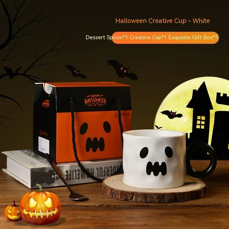 Orange ceramic pumpkin mug with handle on gift box with dessert spoon