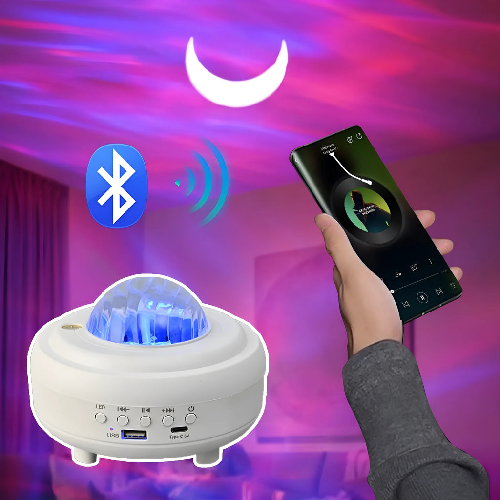 White and black galaxy star projector night light with Bluetooth speaker on a surface.