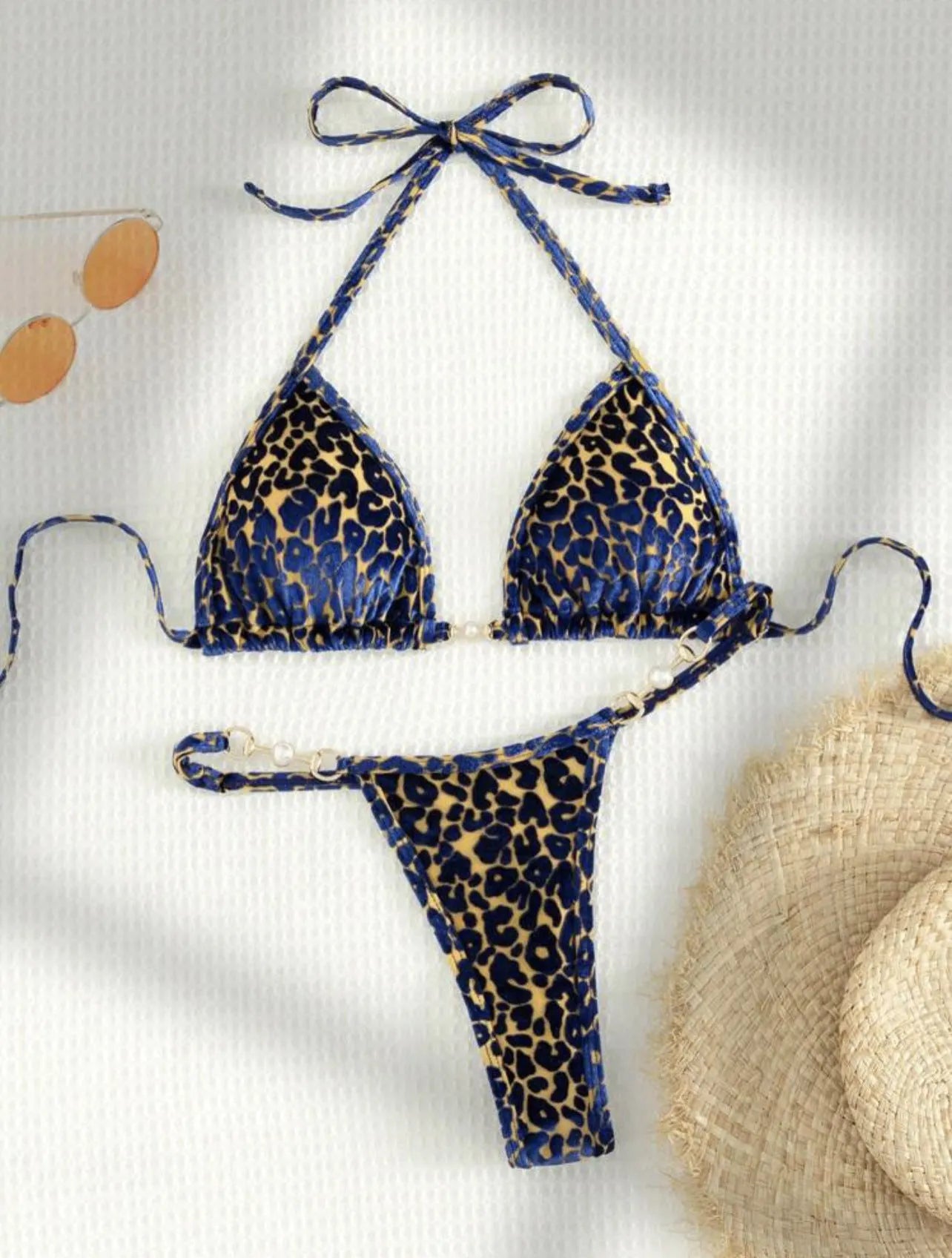 Women's T-shaped leopard print bikini swimsuit in polyester and spandex fabric on a mannequin.