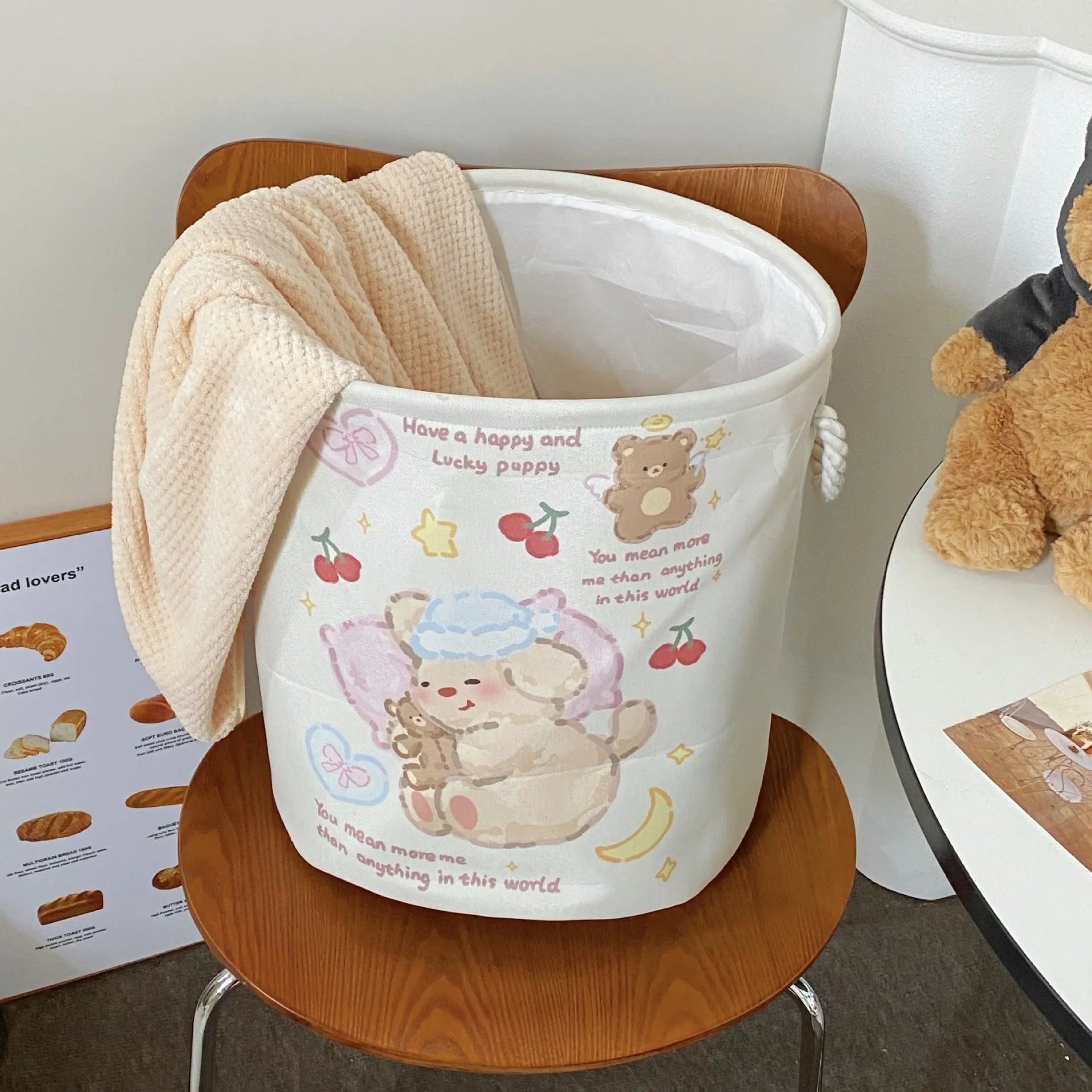 Foldable cotton cloth laundry basket in a character print colour, shown unfolded for use.