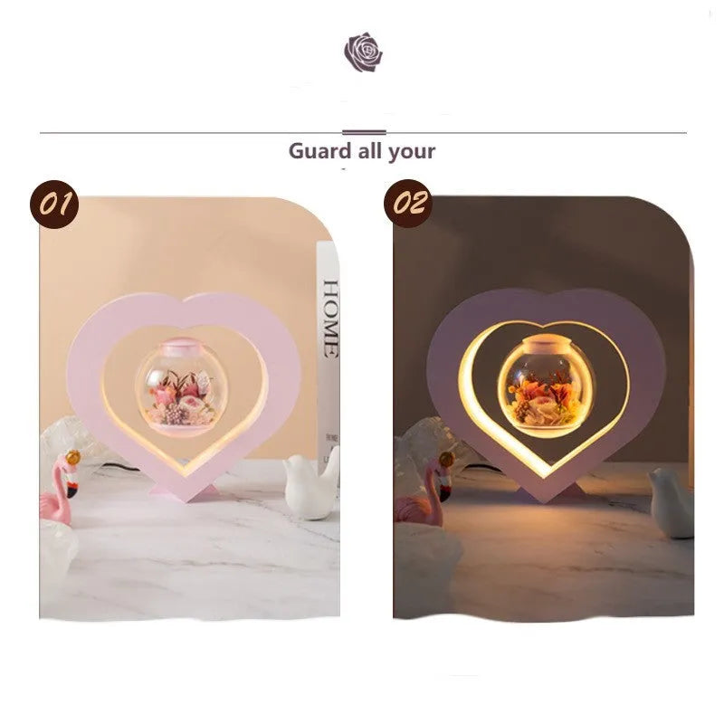 Pink preserved rose ornament with LED lights, shown with and without a decorative base.
