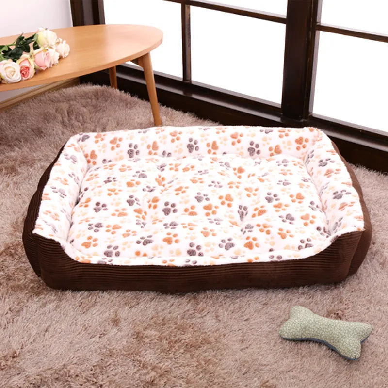 Beige plush sofa dog bed with raised rim for a small dog, showing non-slip base.