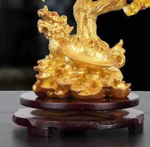 A citrine-coloured resin decorative ornament of a small water turtle and a money tree in Chinese style.