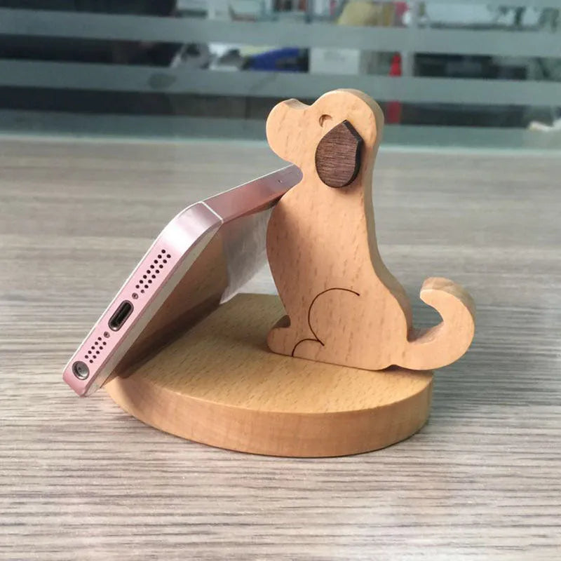 Solid beech wood phone holder with resin puppy decoration and a pound coin in the integrated slot.