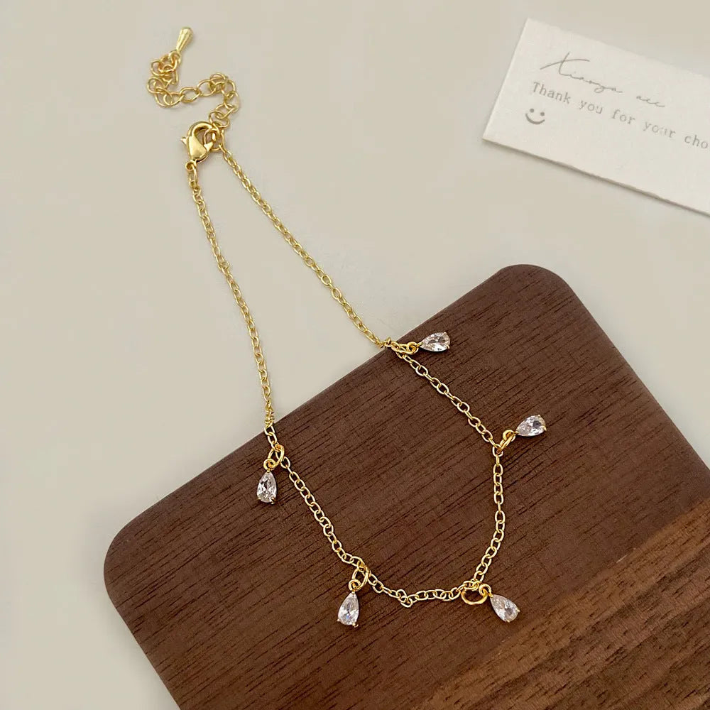 Geometric zircon necklace, earrings, and anklet set in a Korean-style meteor shower design.