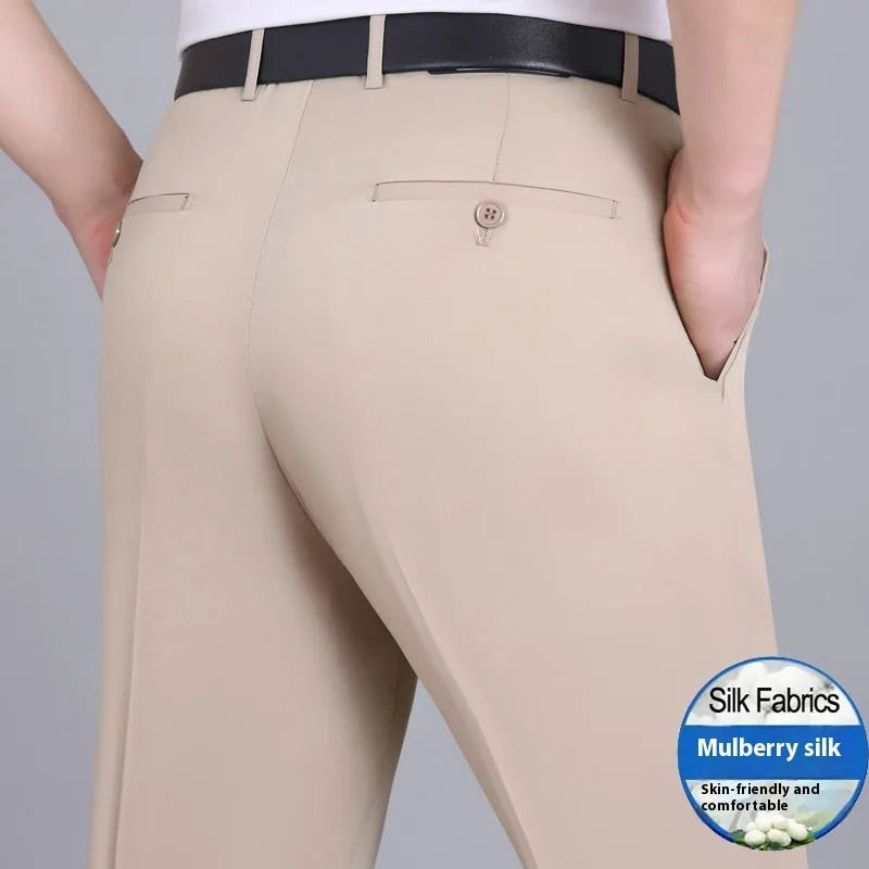 Men's dark blue straight-leg suit trousers with a high waist and non-iron finish on a hanger.