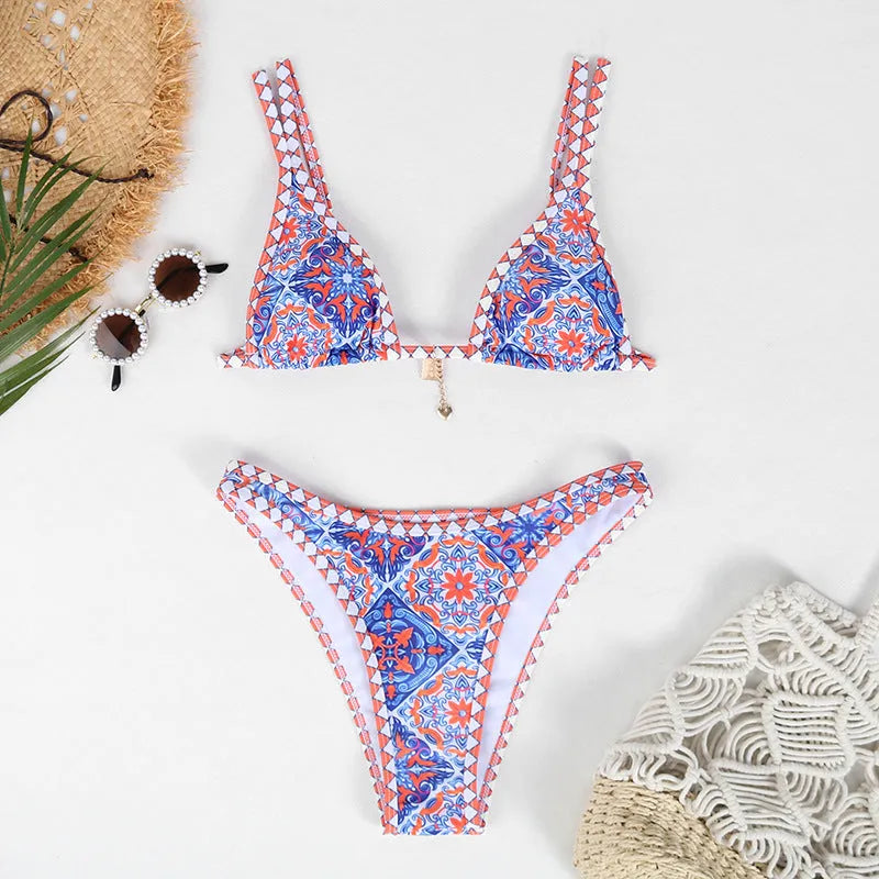 Women's retro-style printed swim bikini set in orange, pink, black, and blue colours on a mannequin.