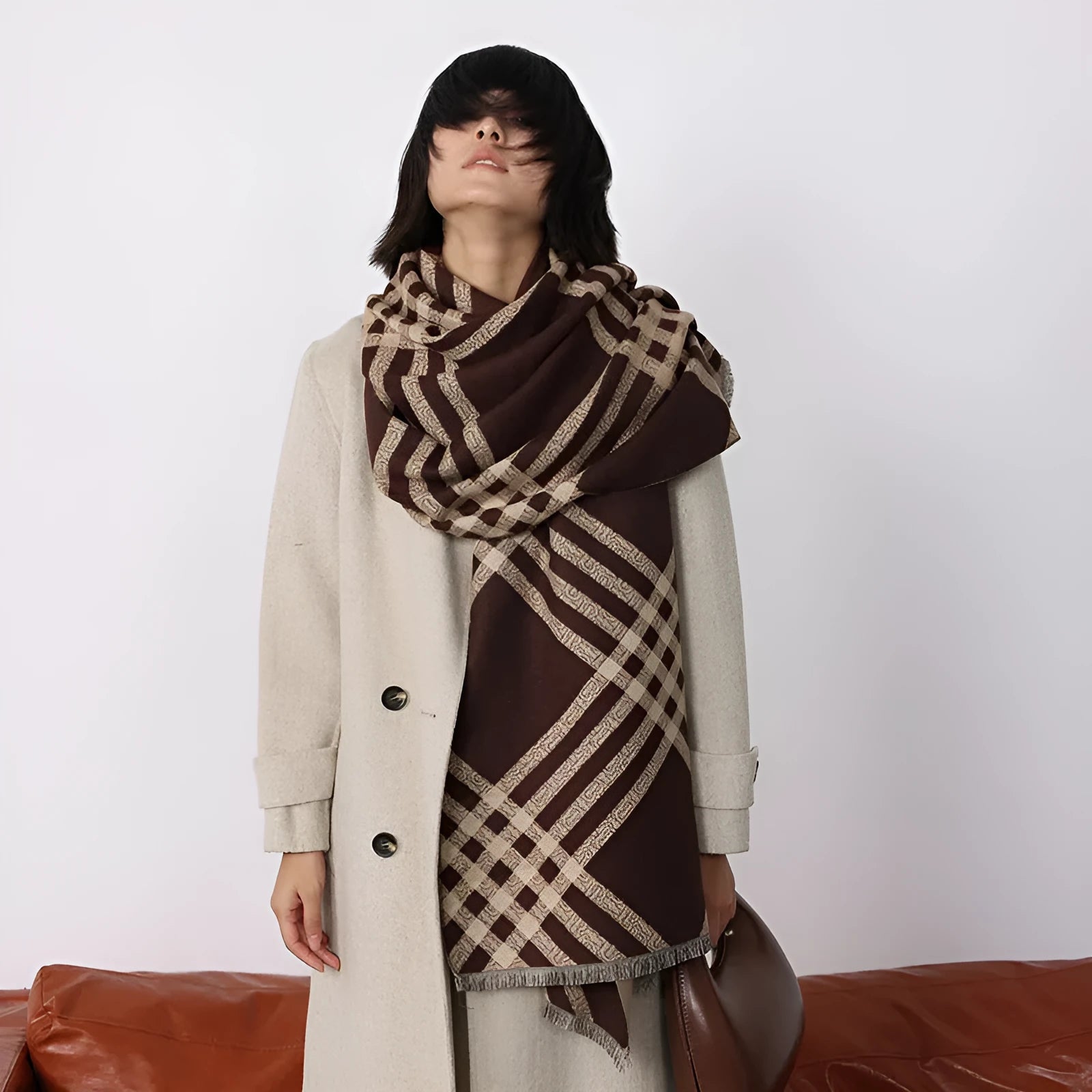 Mid-length brown imitation cashmere winter scarf with tassel trim laid flat.