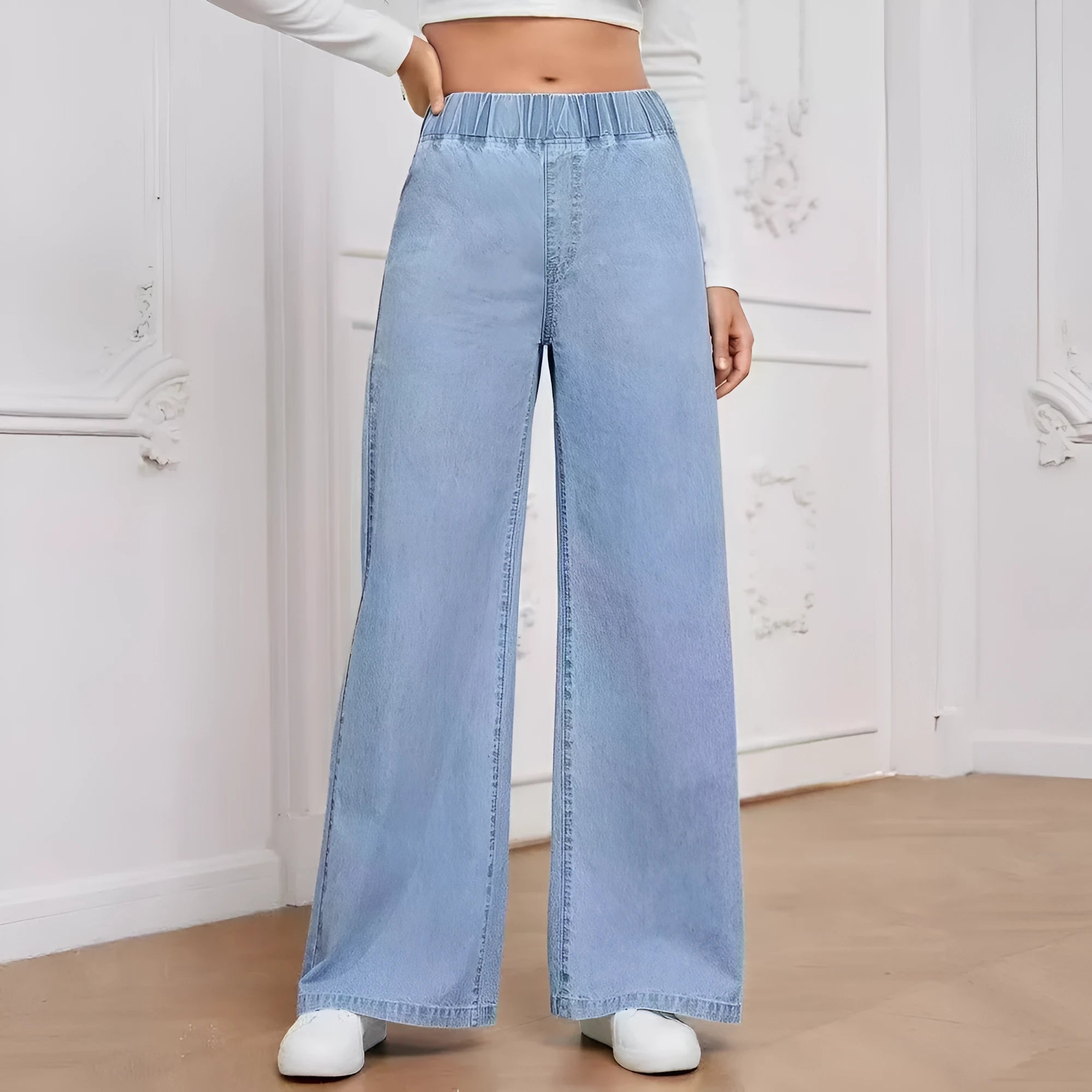 Light blue washed wide-leg straight denim trousers on a hanger, showing mid waist and zip fly.