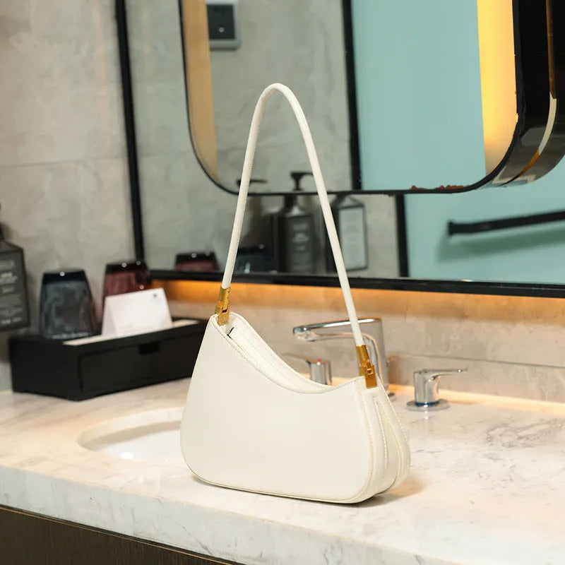 Retro oval women's underarm bag in PU leather with single shoulder strap shown in multiple colour options