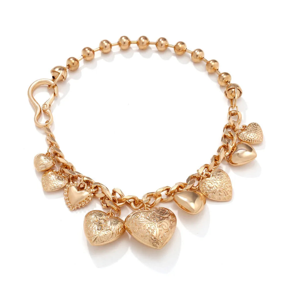 Gold carved heart-shaped pendant necklace on an adjustable metal chain.