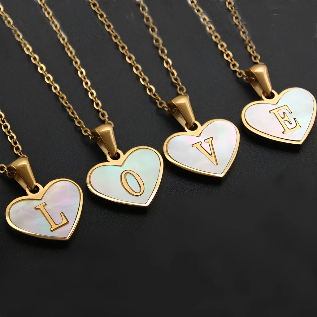 Gold plated heart-shaped white shell necklace with personalised text on a stainless steel chain.