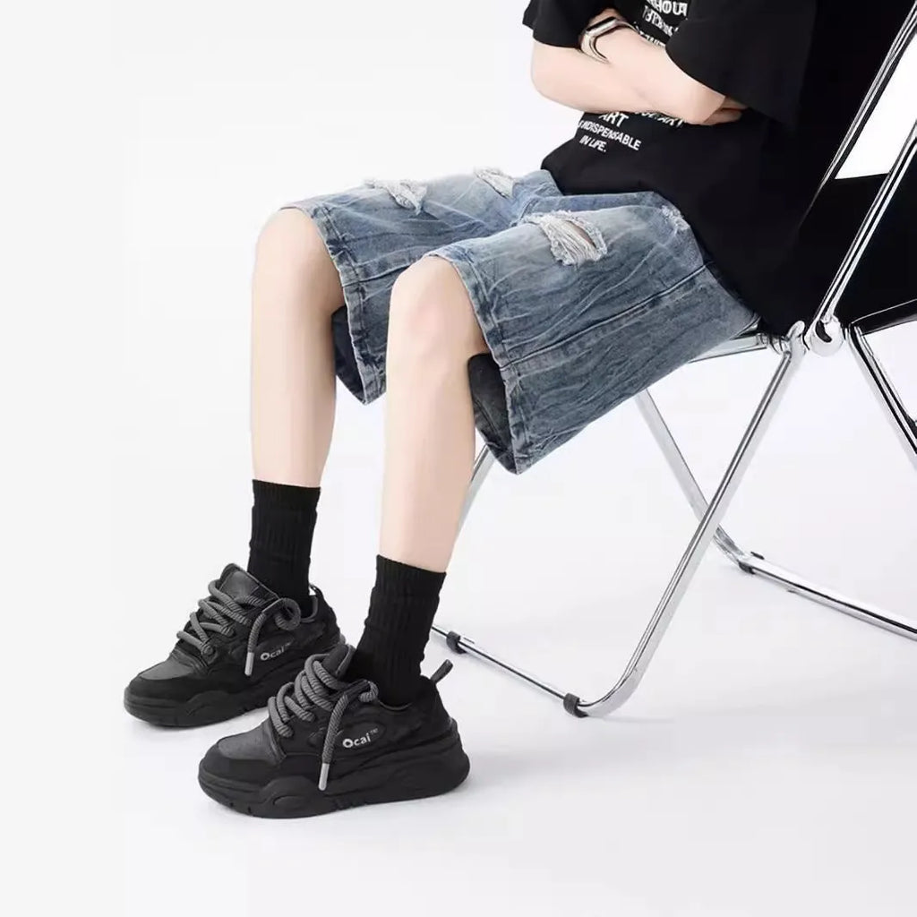 Retro washed denim shorts with loose fit and distressed ripped detailing in black or blue