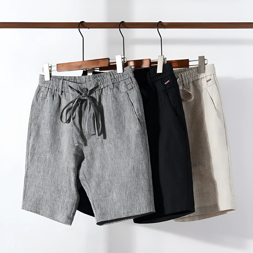 Men's 100% linen straight shorts in black, front view, mid-waist with zipper fly and pocket detail