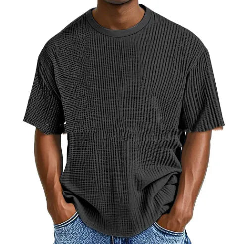 Man wearing a light blue cotton blend waffle knit short sleeve casual T-shirt.