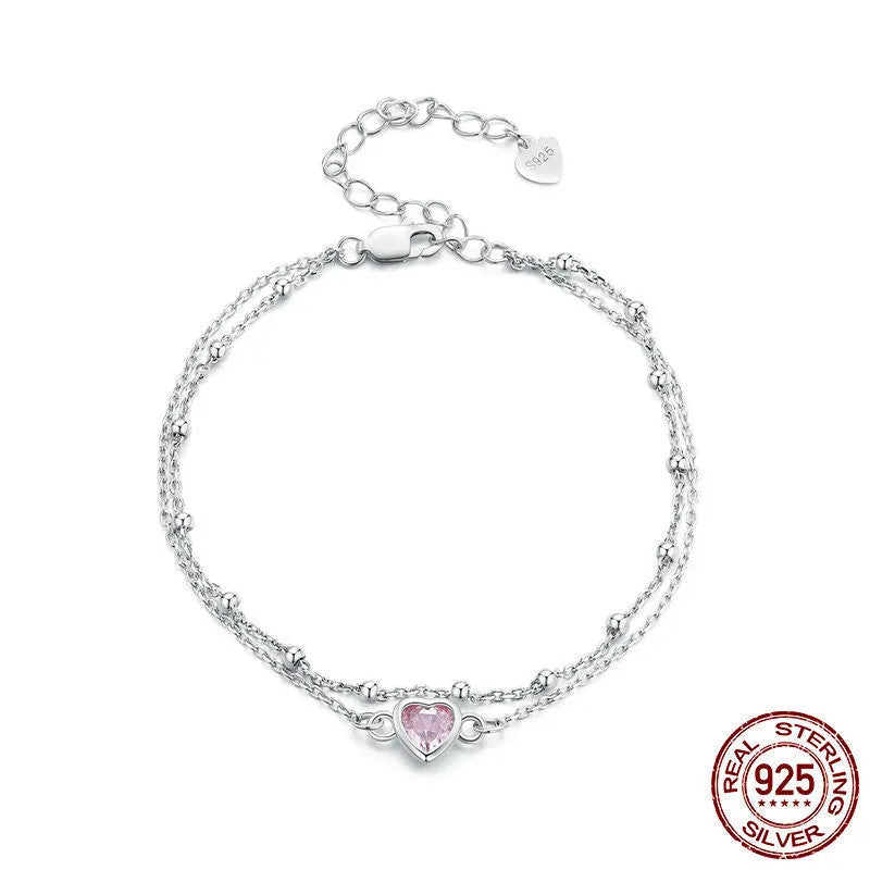 Women's sweet style sterling silver bracelet with small heart pendant on an adjustable chain.
