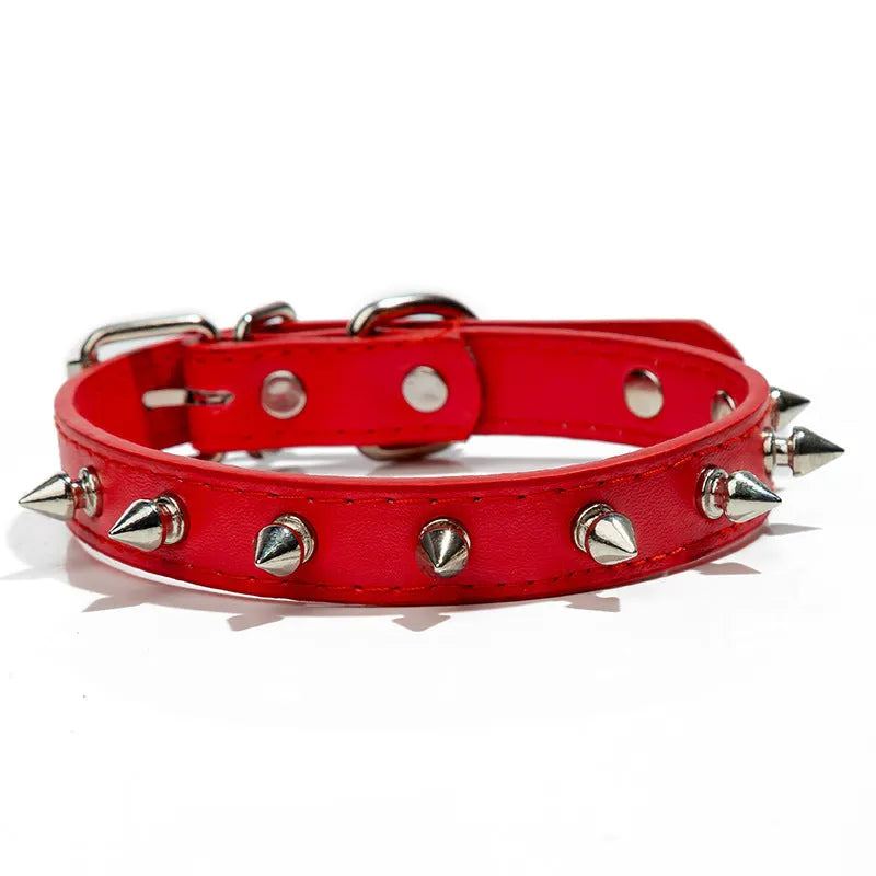 Close-up of a studded black PU leather dog collar with metal spikes and a silver alloy buckle fastener.