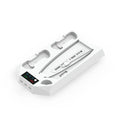 White PS5 charging base and radiator stand holding console, controllers, remote, and headset