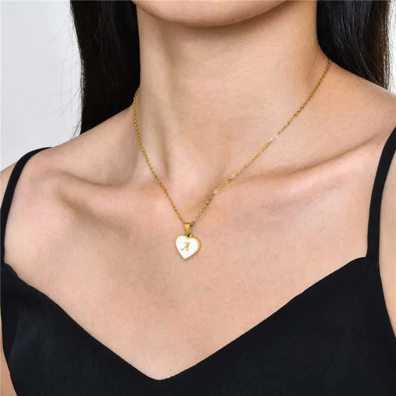 Gold plated heart-shaped white shell necklace with personalised text on a stainless steel chain.