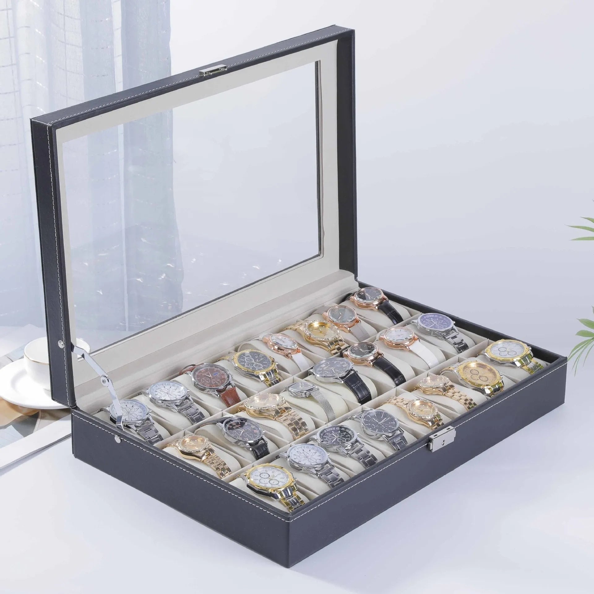 Grey leather watch storage box with a transparent dust cover, showing internal watch slots.