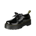 Black and white women's thick-soled leather shoes with ribbon cross straps and laces.