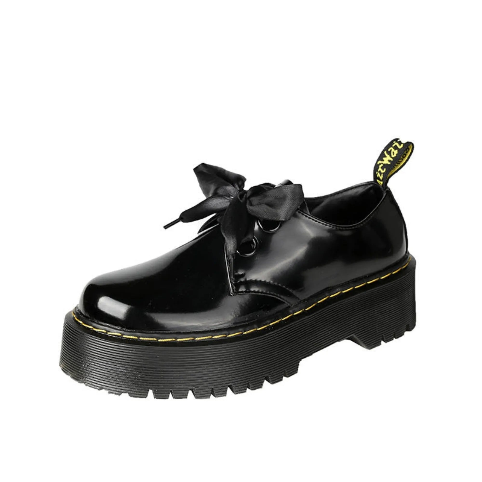 Black and white women's thick-soled leather shoes with ribbon cross straps and laces.