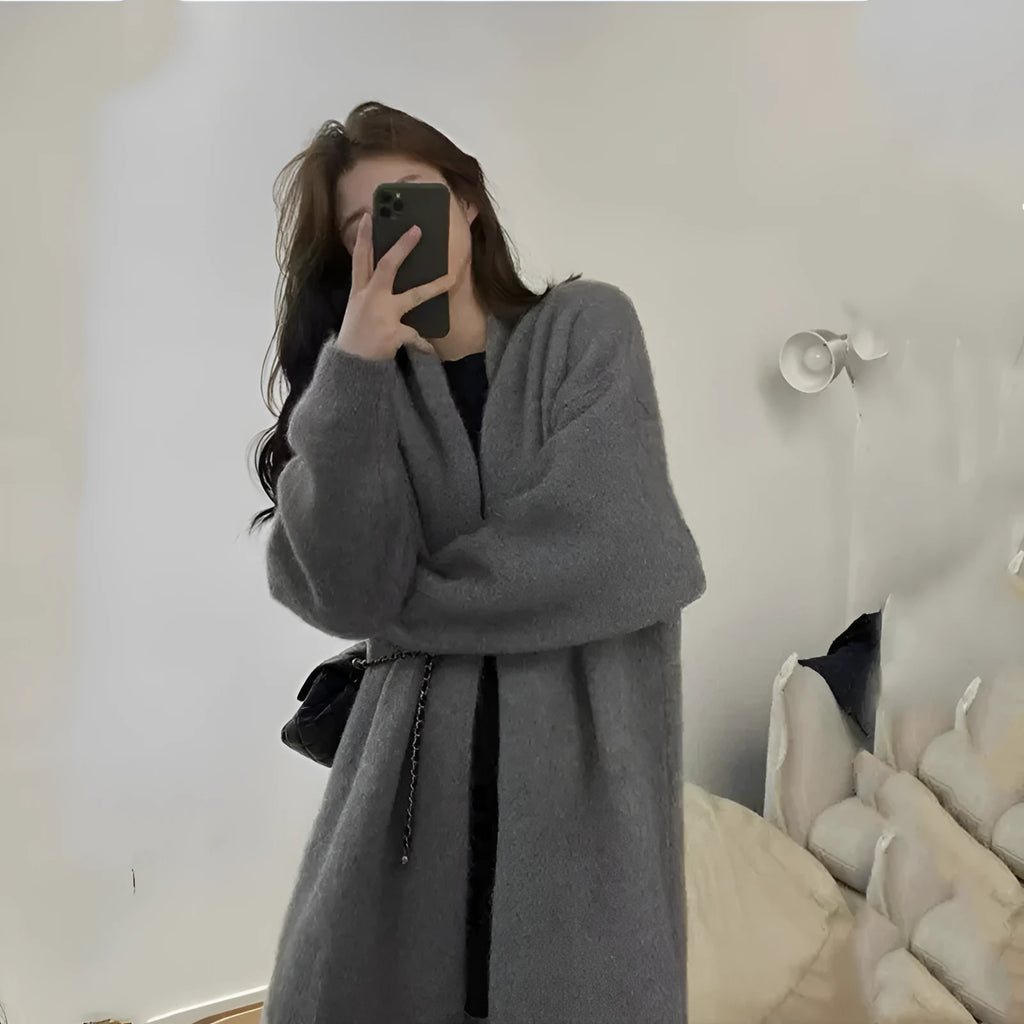 A loose, thick chenille cardigan sweater with a 3D textured pattern in a dark grey colour.