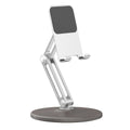 Silver aluminium desktop phone stand with wood grain base, folded and ready for use on a desk with a smartphone