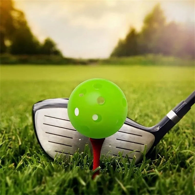 Six multi-coloured golf practice balls in red, orange, blue, green, white, and yellow, shown in a net bag.