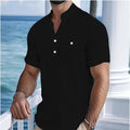 Man wearing a light-coloured linen blend T-shirt with a stand collar and short sleeves.