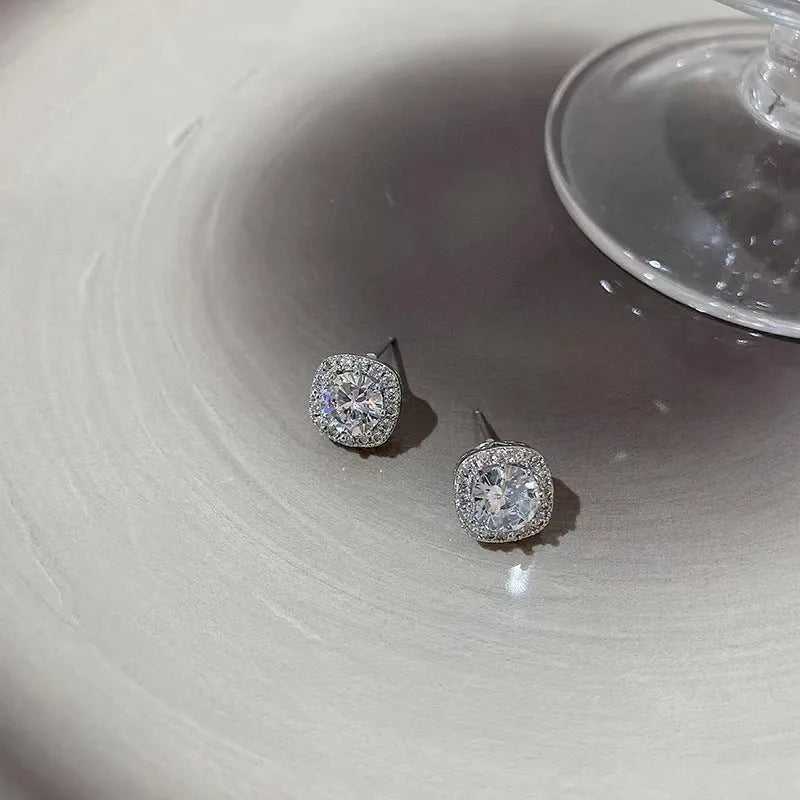 A pair of women's geometric square diamond earrings in a simple cold style, shown in silver and gold alloy colours.
