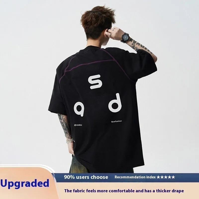Loose fit black cotton t-shirt with white letter print, short sleeves, and round neck.