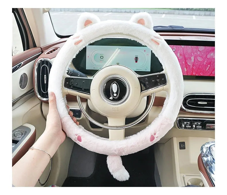 Plush furry steering wheel cover with embroidered panda face, fitted on a car steering wheel.
