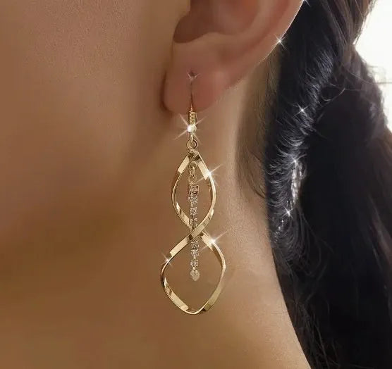 Women's gold geometric earrings with spiral design and diamond shape on alloy construction