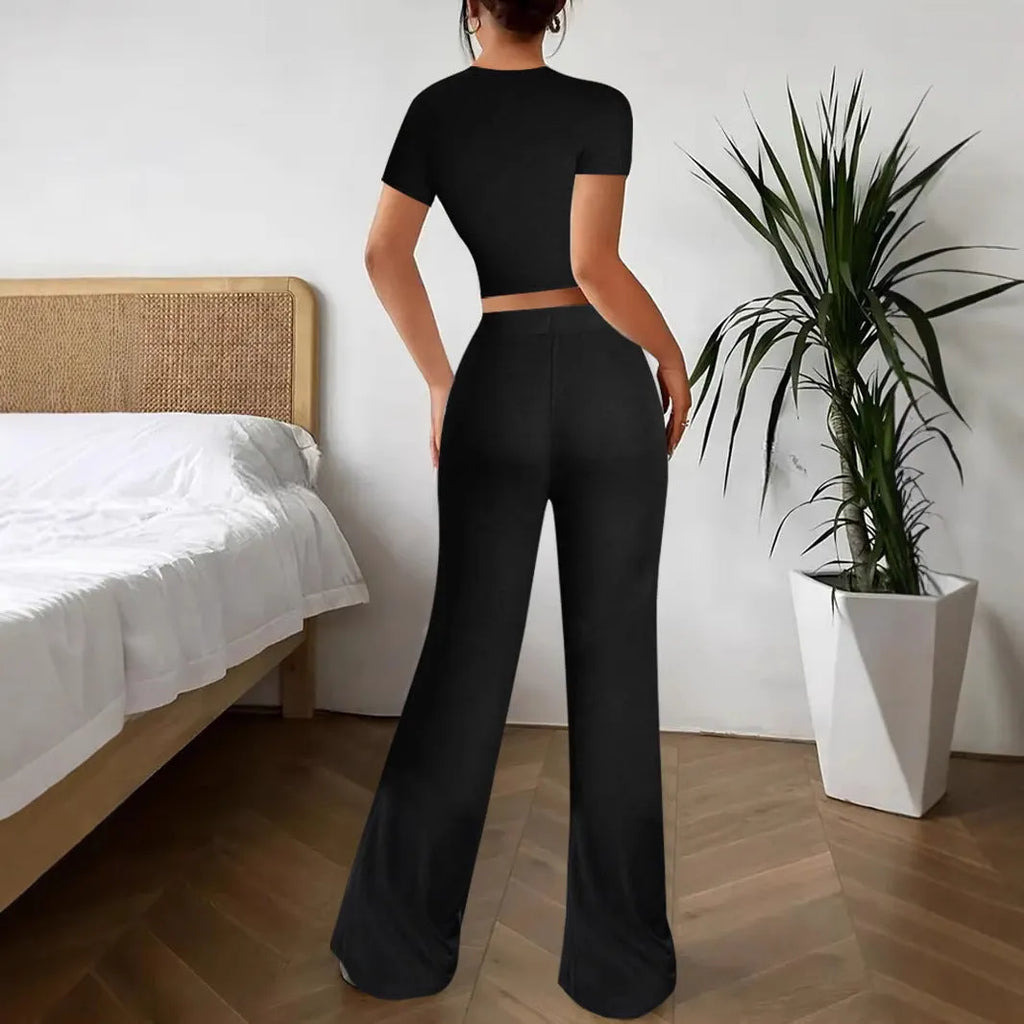 Black high-waisted trousers and short sleeve T-shirt co-ordinated suit for women.