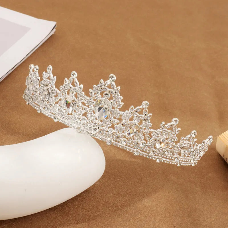 Gold alloy crown-shaped wedding hair headdress with electroplated finish on neutral background