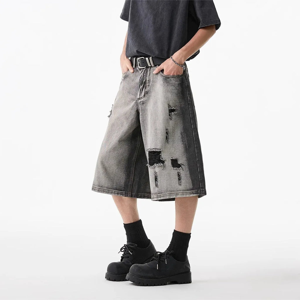 Grey water washed denim shorts with hole detailing and loose retro fit