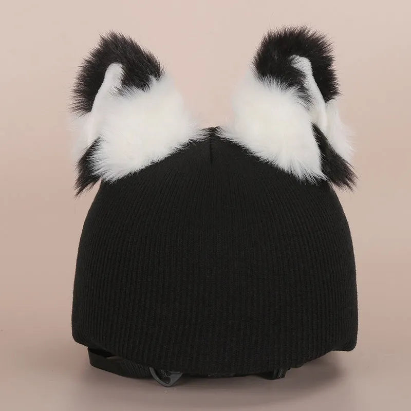 Colourful plush cartoon hat decoration sitting on top of a ski helmet