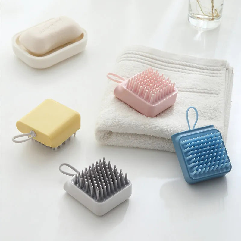 Pet bath brush with soft TPR combs for dog and cat grooming, available in blue, pink, white, and yellow.