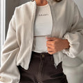 Women's off-shoulder short coat with lantern sleeves in brown colour showing round neck and pocket details