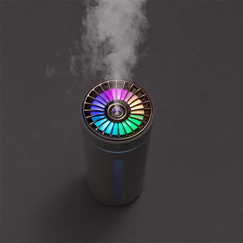 Black portable USB rechargeable humidifier with colourful lights on a car cup holder.