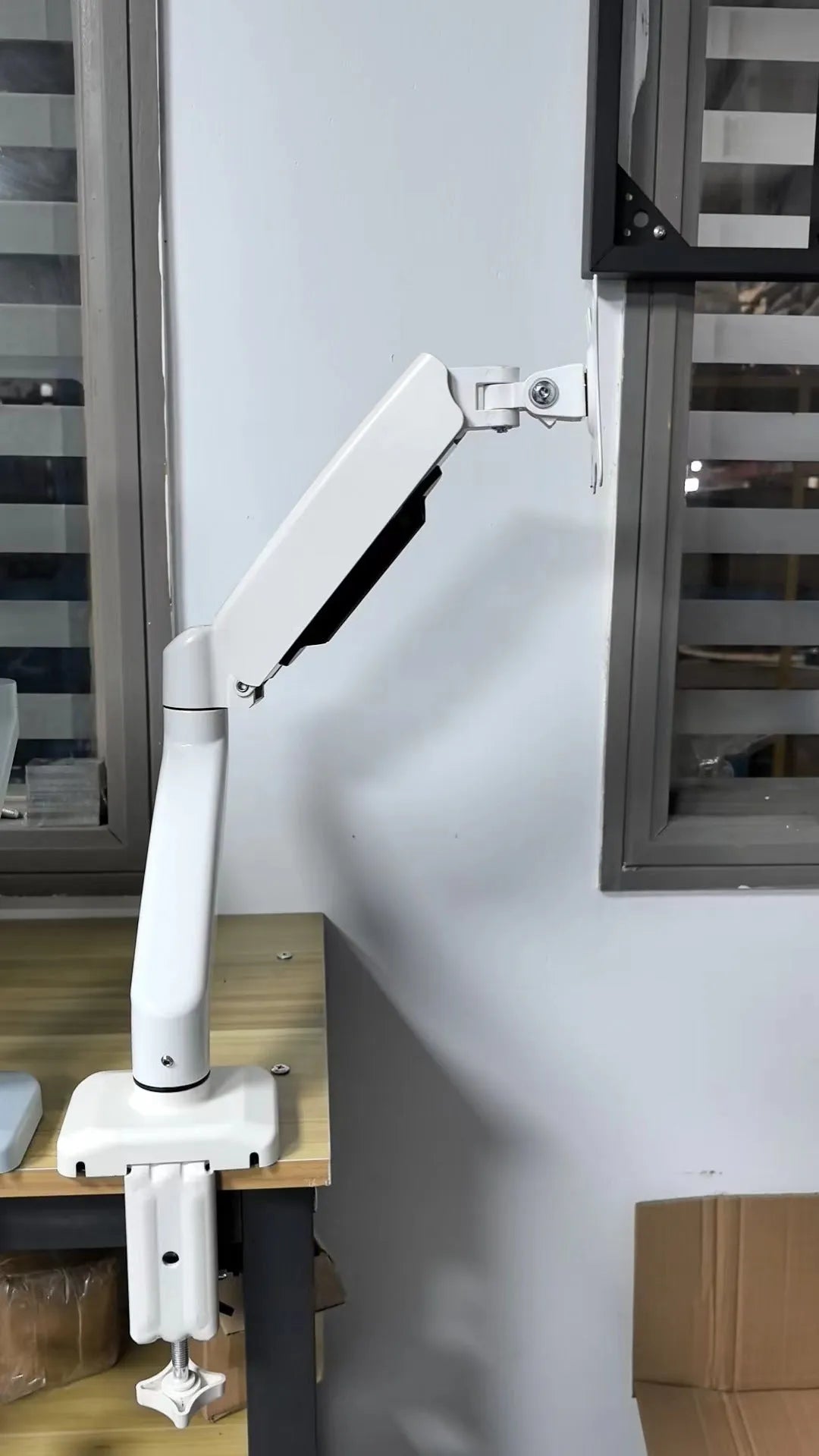 Black table-style LCD screen bracket showing height adjustment and rotation features for monitor mounting