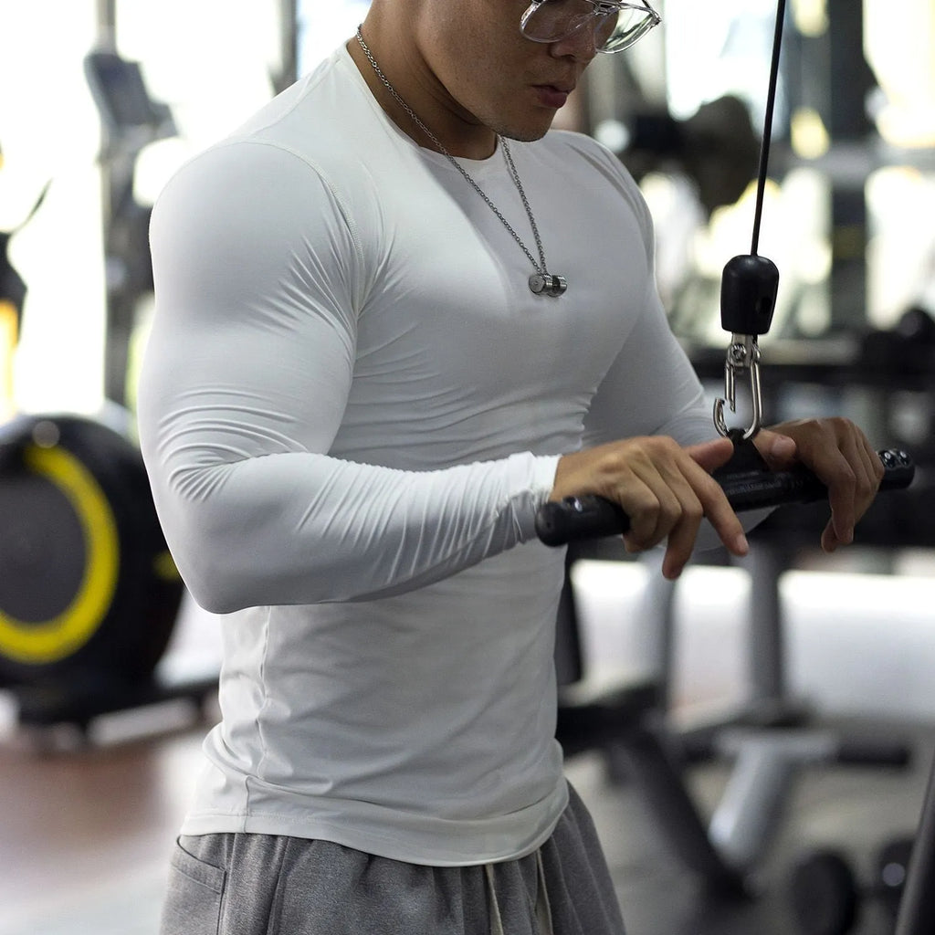 Men's black fitness tights with long sleeves and slim fit design for athletic activities