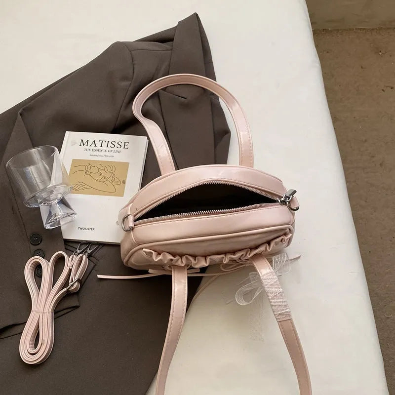 Women's bandage bow handbag in PU leather with shoulder strap and sewing thread detail
