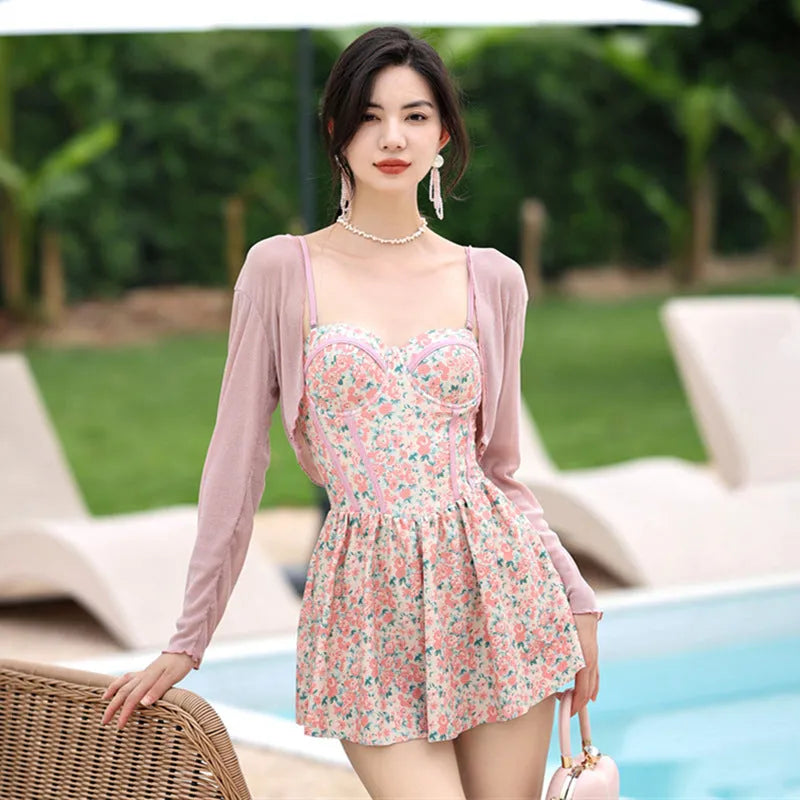 Women's floral pattern one-piece swimsuit with suspender straps in pink or green colour options