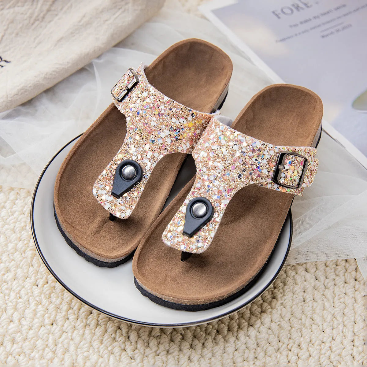 Gold frosted cork flip-flops with artificial leather upper and textured PVC sole.