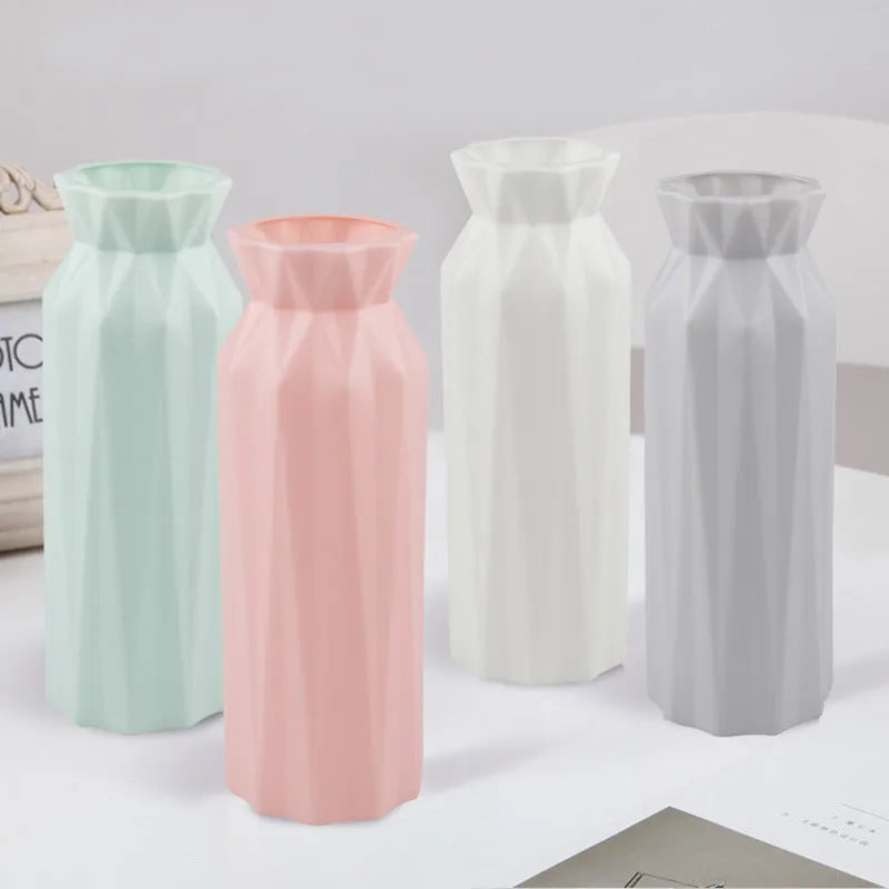 Green plastic melamine vase with a wide, stable base on a wooden surface.
