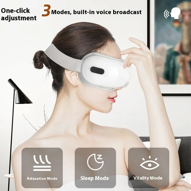 White rechargeable eye massager with hot compress and airbag functions on a table